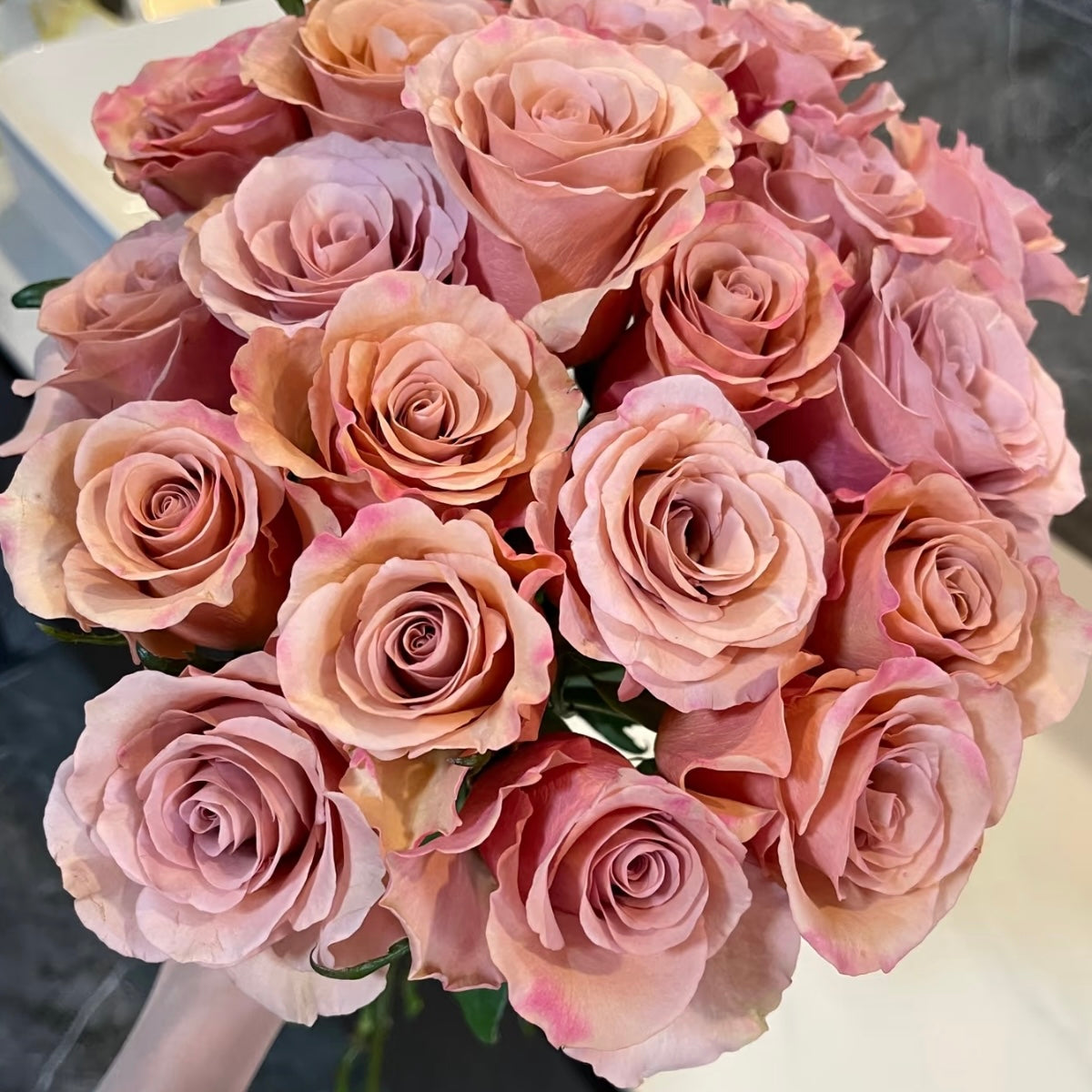 Bouquet of Moab Roses featuring large spiral blooms and warm apricot-mocha tones.